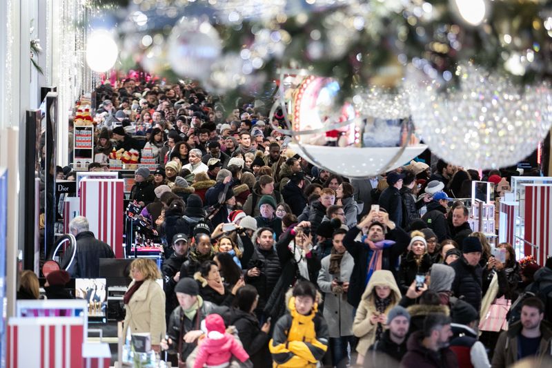 Shoppers enter the Macy's flagship store in New York on Nov. 22