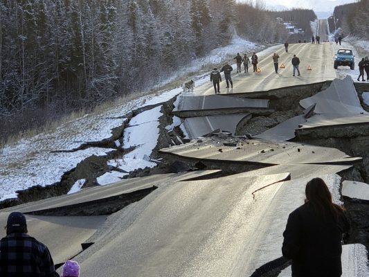 In this photo provided by Jonathan M. Lettow, people walk along Vine Road after an earthquake, Friday, Nov. 30, 2018, in Wasilla, Alaska. (Jonathan M. Lettow via AP)