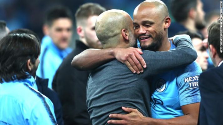 City manager Pep Guardiola exchanges a hug with defender Vincent Kompany.