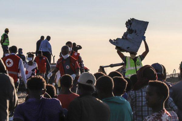 A man carried a piece of debris on his head at the crash site.