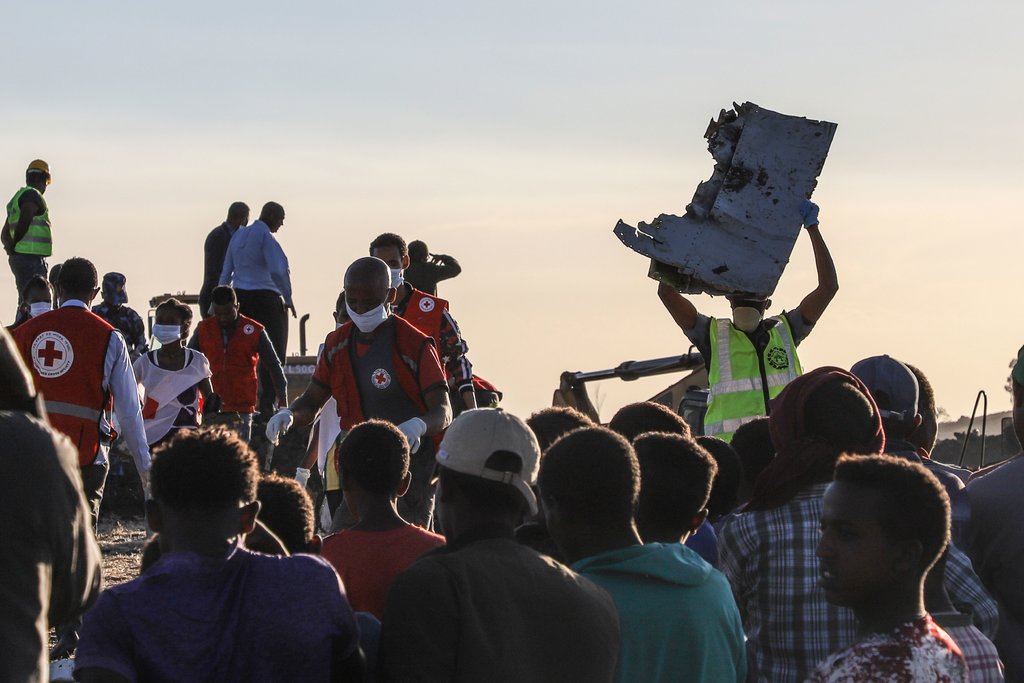 A man carried a piece of debris on his head at the crash site.