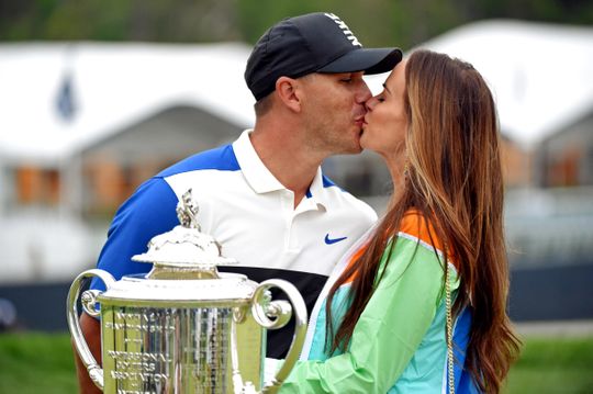 Brooks Koepka celebrates winning the PGA Championship with a long-awaited kiss from his girlfriend, Jena Sims