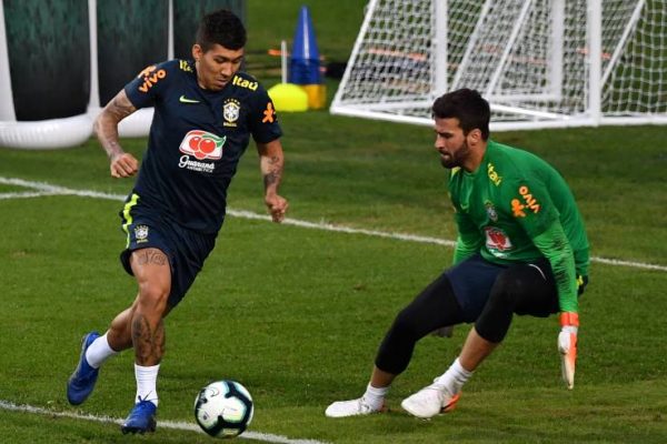 Brazil's Roberto Firmino (L) and goalkeeper Alisson (R) take part in a training session at the Pacaembu stadium, in Sao Paulo, Brazil, on June 11 ahead of the Copa America football tournament