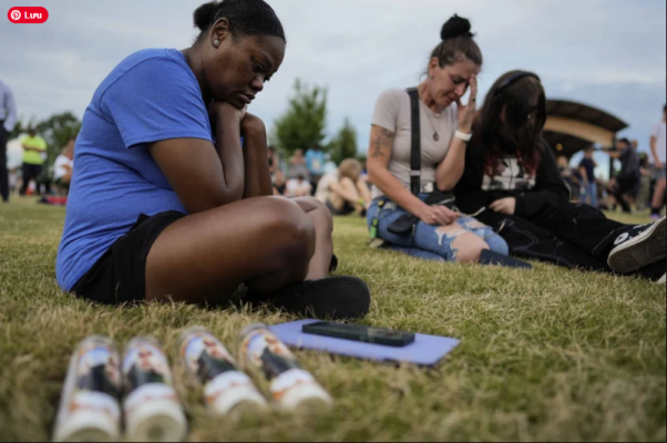 Mourners pray during a candlelight vigil for the slain students and teachers at Apalachee High School